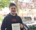 Michal with Driving test pass certificate